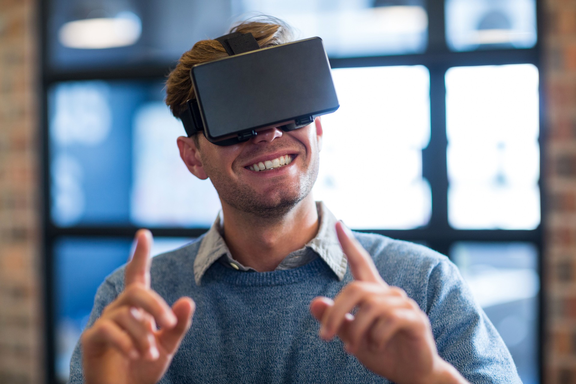 Businessman gesturing while using virtual reality headset