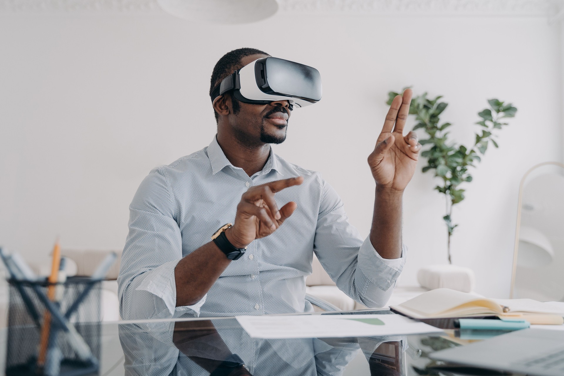 Businessman in vr headset clicks virtual buttons. Modern technology for business and creativity.